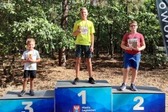 zdjęcie przedstawia zwycięzców biegu na podium w kategorii młodzież