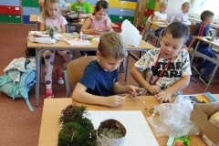 zdjęcie przedstawia uczniów klasy 1a wykonujących jesienne prace plastyczne